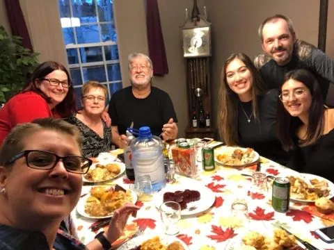 happy Newfoundland family hosting an international student for traditional supper