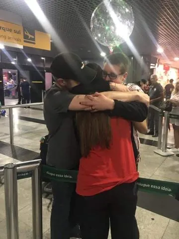 international students hugging at an airport
