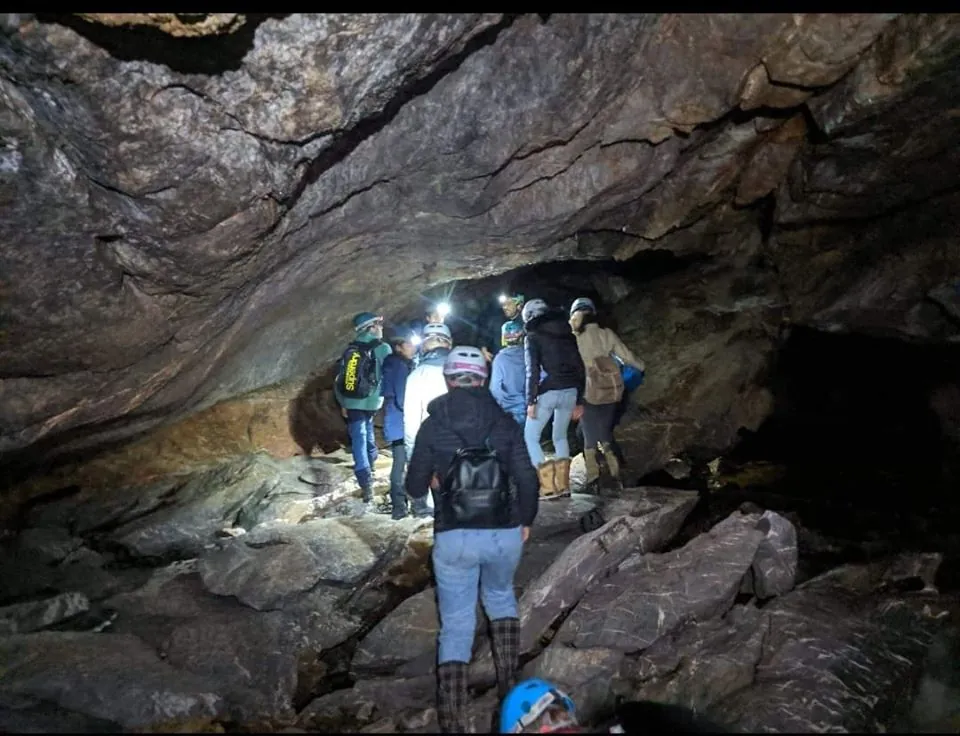 students exploring a cave