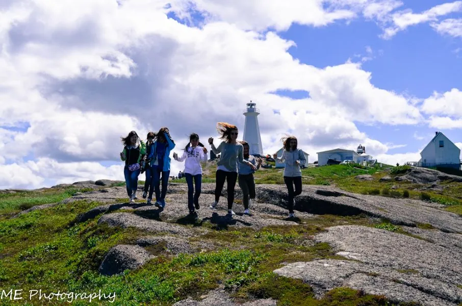Students walking toward a lighthouse